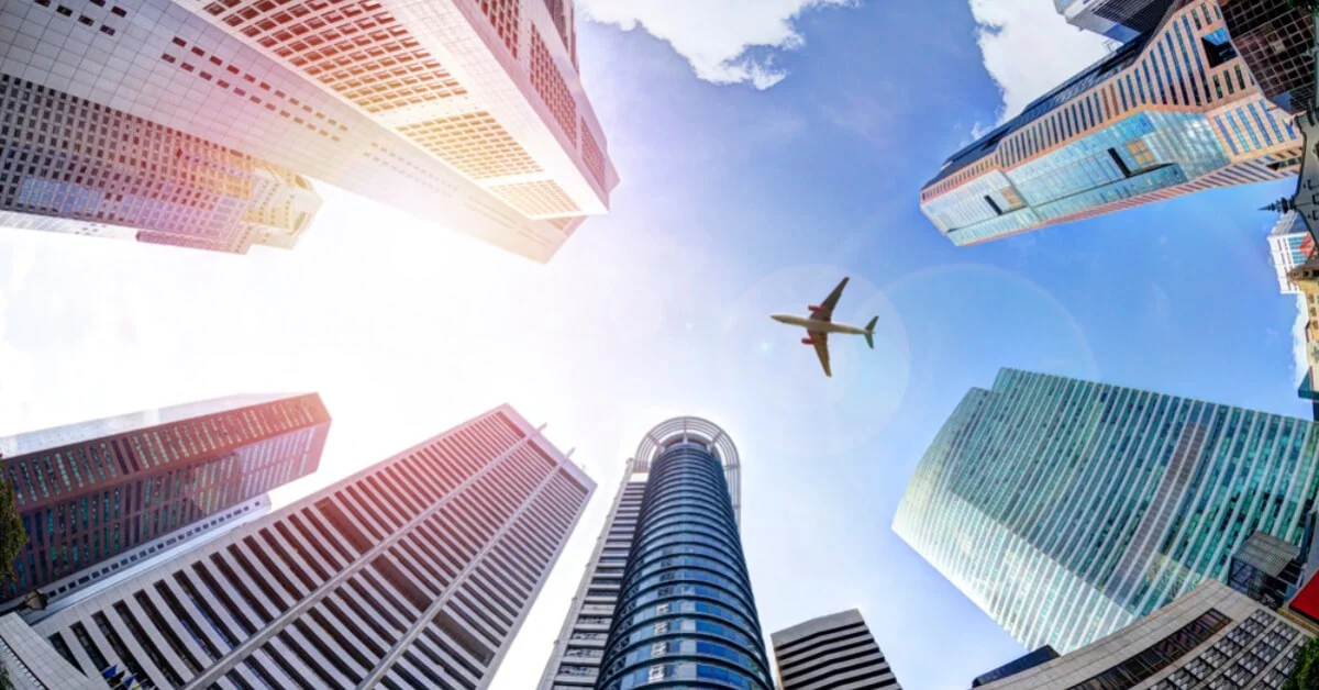 a plane flying in a large city