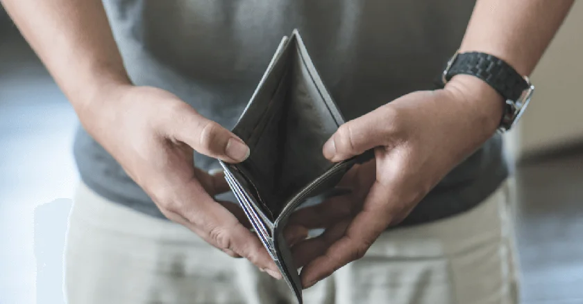 A man wearing a watch holding an empty wallet