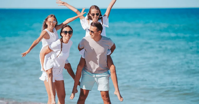 A family of four having fun on the beach